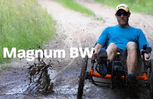 Rider charging through mud on a Greenspeed Magnum BW